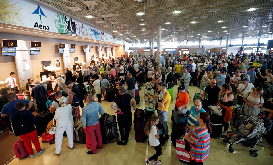  Thomas Cook passengers queue in front of check-in desks on the second day of repatriations at Reus airport, next to Tarragona in Spain