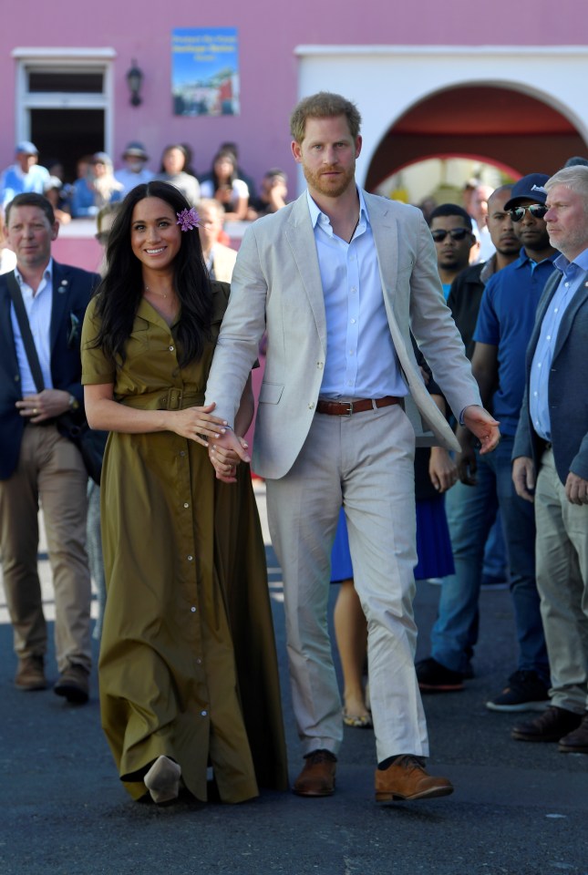  Harry and Megah hold hands during the walkabout