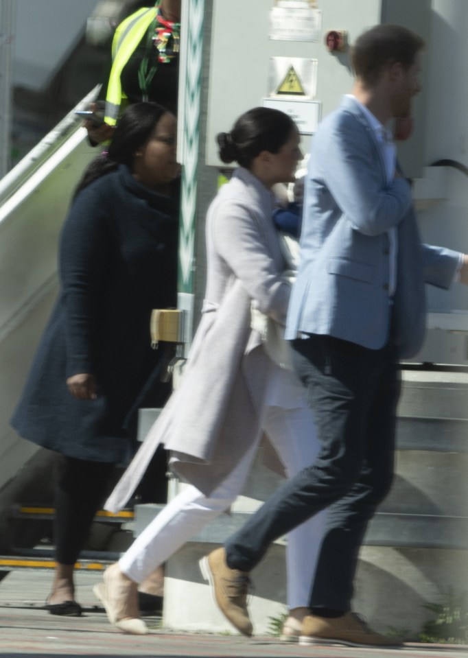  The nanny was spotted behind Meghan as they touched down in Cape Town