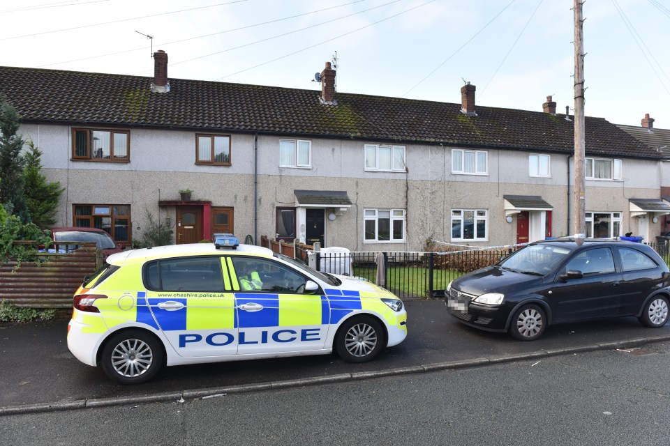  Police outside the Widnes home where a 43-year-old woman was attacked by two dogs and died