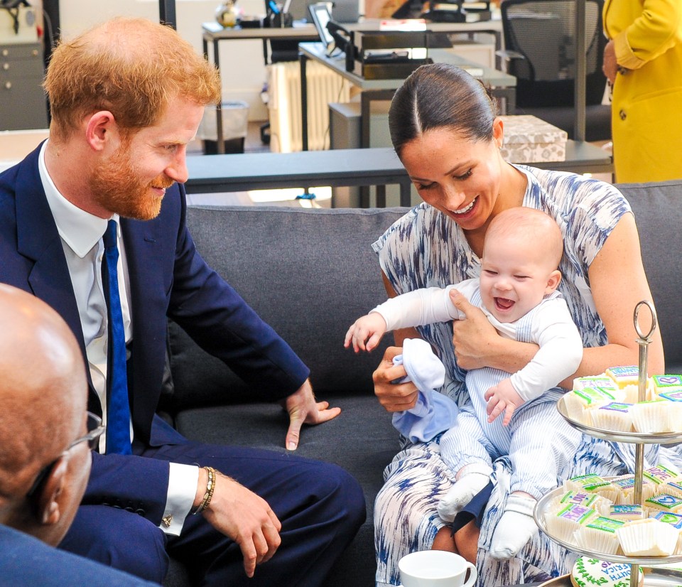 Meghan cradled Archie as the family met Archbishop Desmond Tutu