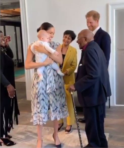 Proud mum Meghan bounces Archie in her arms as she tries to keep her four-month-old entertained