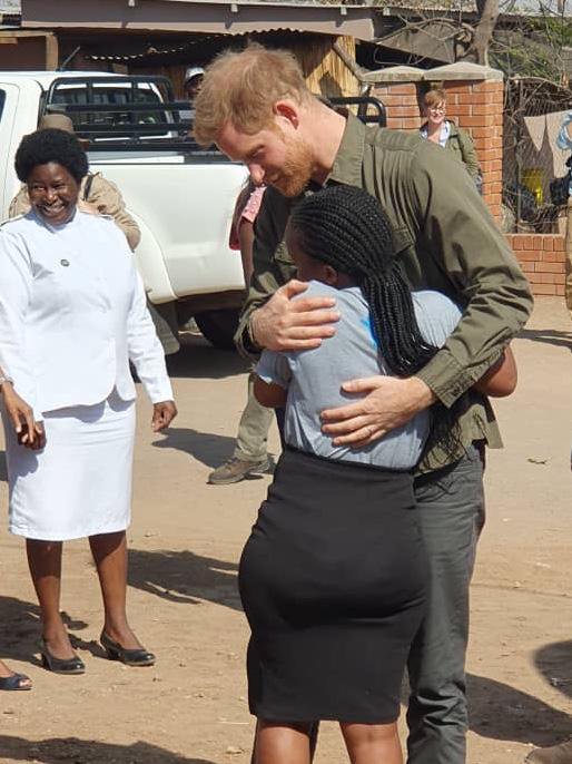 Prince Harry hugs Let Youth Lead advocate Tlotlo during his trip today