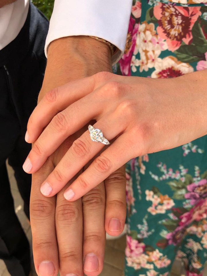 The couple show off the gorgeous engagement ring