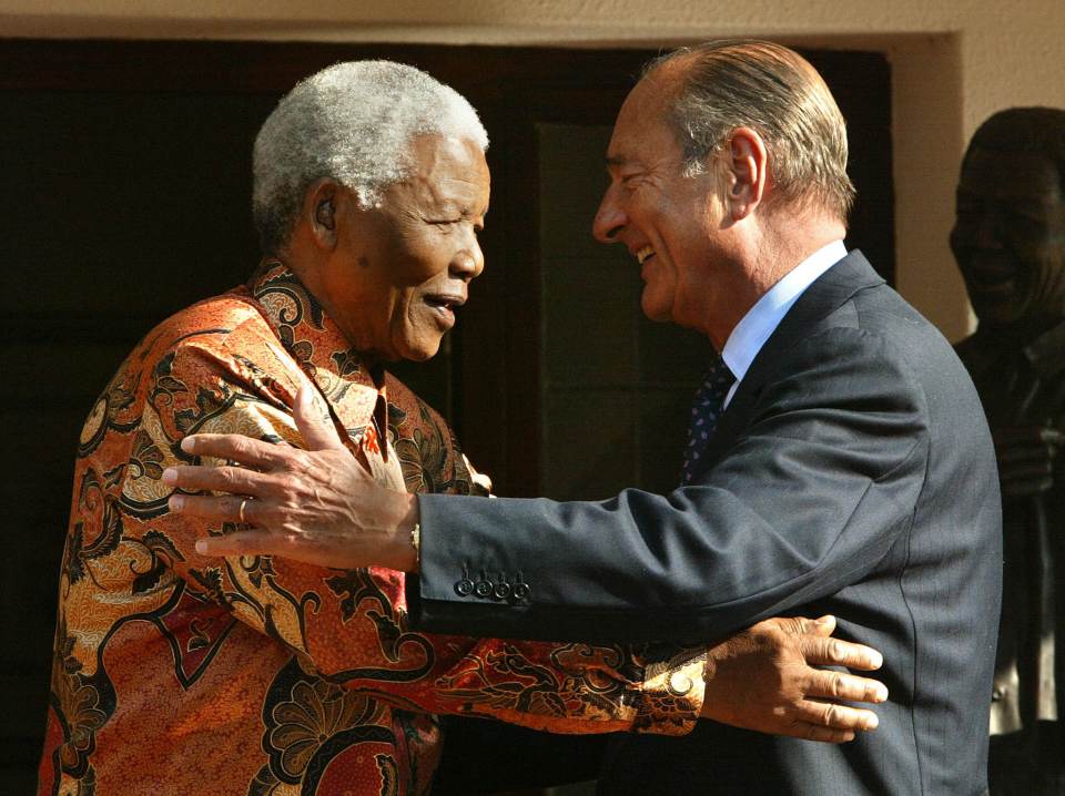  Jacques Chirac hugs Nelson Mandela after their meeting in Johannesburg in 2002