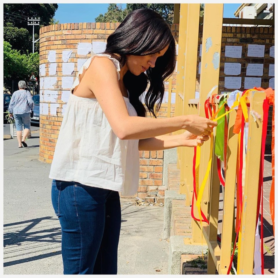  Meghan ties a yellow ribbon outside the post office where a girl's brutal murder has shocked South Africa