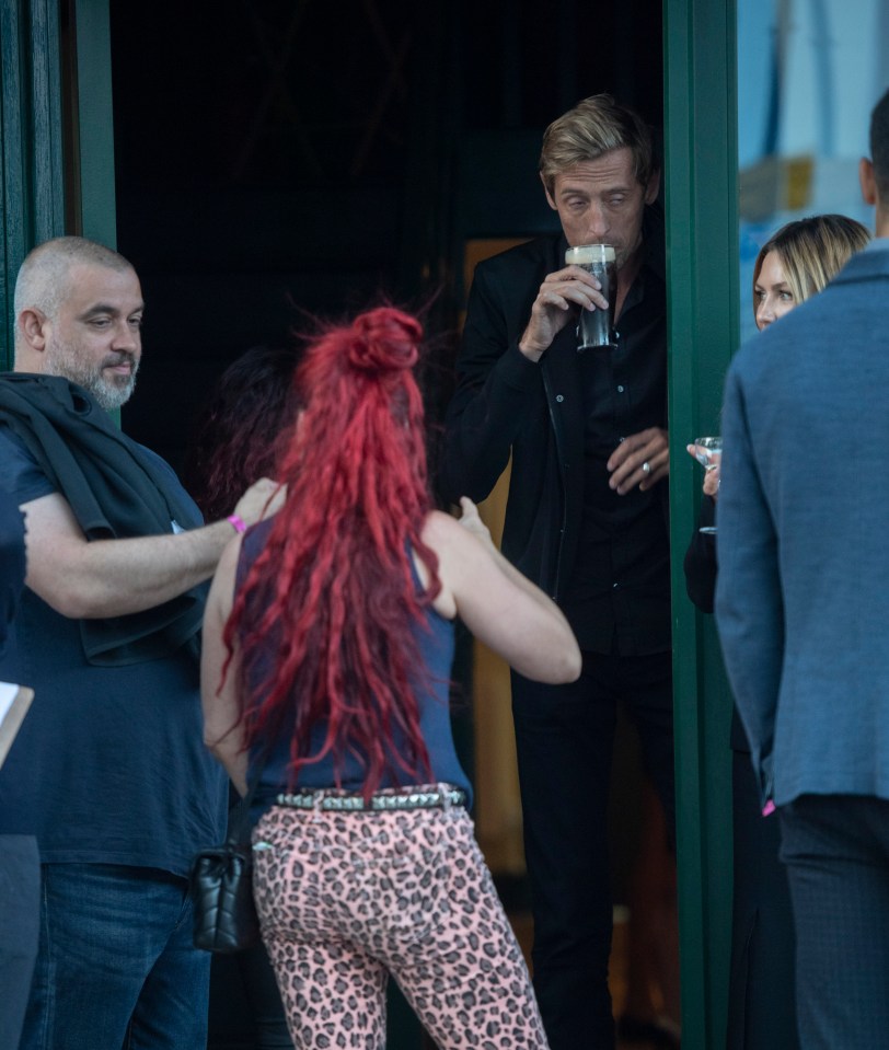  Peter takes a swig of his drink outside the bash