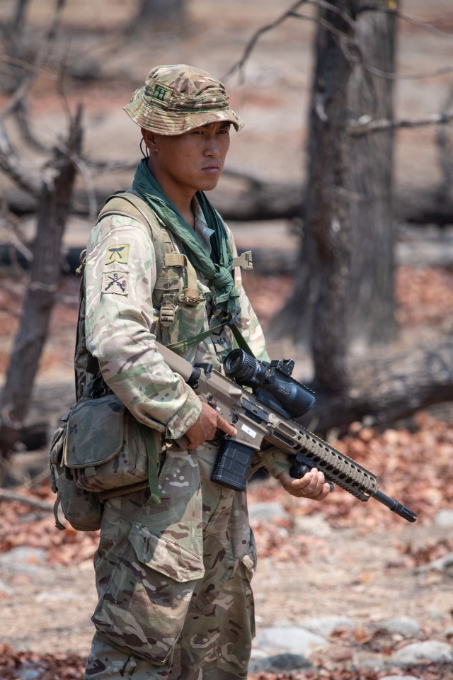  A Gurkha stands by armed with a rifle as the exercise continues