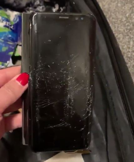 Her work phone screen was smashed from the suitcase