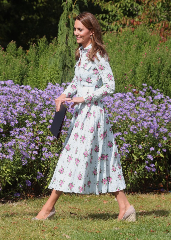  Blending in beautifully in an Emilia Wickstead rose-print dress and raffia wedges while opening the Back to Nature play area in Wisley, Surrey