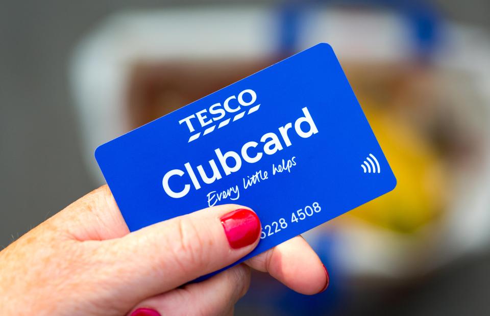 Tesco Clubcard in hand