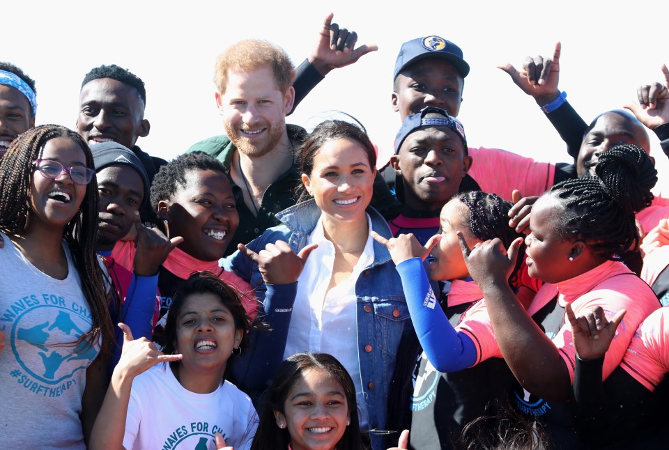  Prince Harry and Meghan with surf mentors at Monwabisi Beach, Cape Town