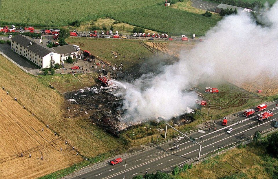  The smouldering scene of the crash - four people on the ground were killed when the supersonic jet slammed into a hotel building