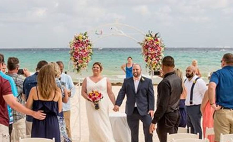  The stranger ruined several shots during the ceremony despite the beach being cordoned off