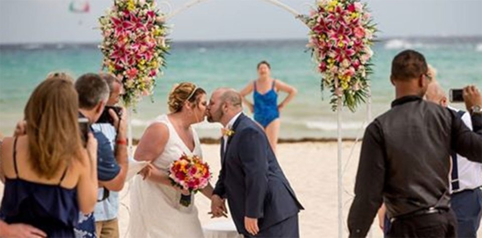  A bride and groom's first photo as man and wife was photo-bombed by a passing swimmer