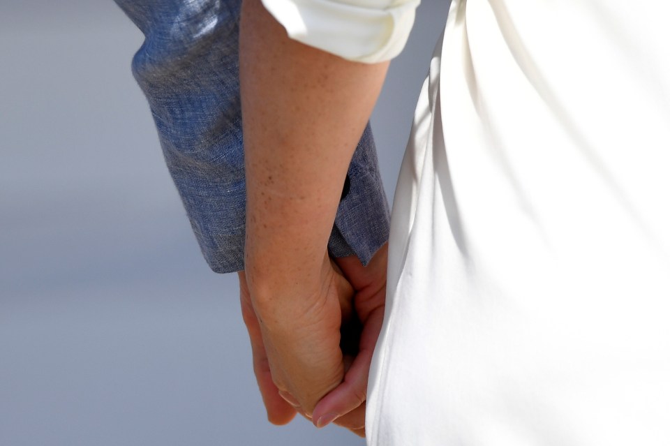  Harry and Meghan seemed every inch the loving couple as they held hands on their stroll round the township