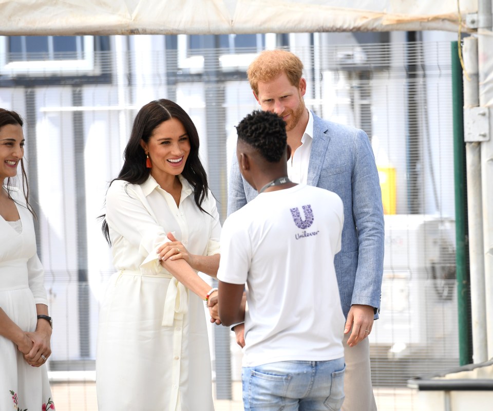  Meghan shook hands with a young lad in an allotment in the township