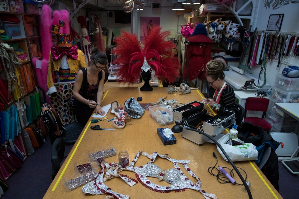  Costume designers work on the elaborately decorated outfits at the Moulin Rouge workshops