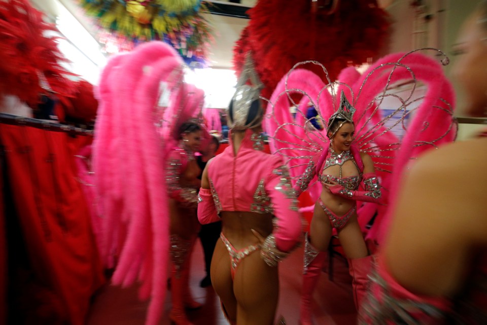  Dancers putting the last-minute touches to their looks before the show