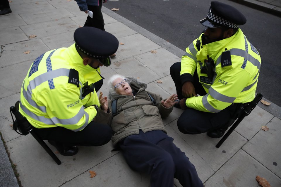  An activist lies on the ground on the first day of a fortnight of disruption