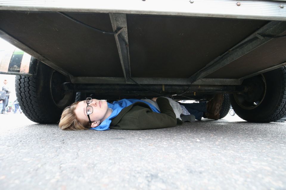  Protesters are lying under a trailer parked in the middle of the road at Trafalgar Square