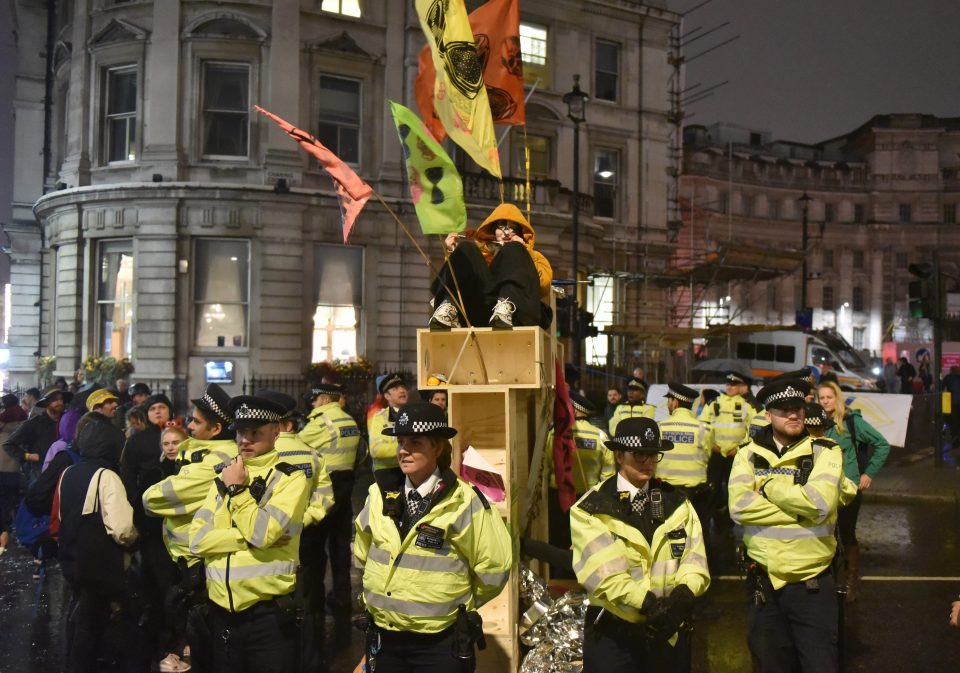 Police surround a protester in Trafalgar Square