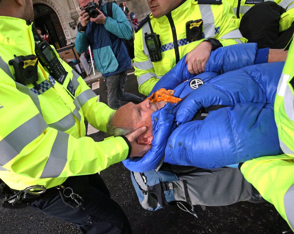  Police arrest an elderly protester at Millbank