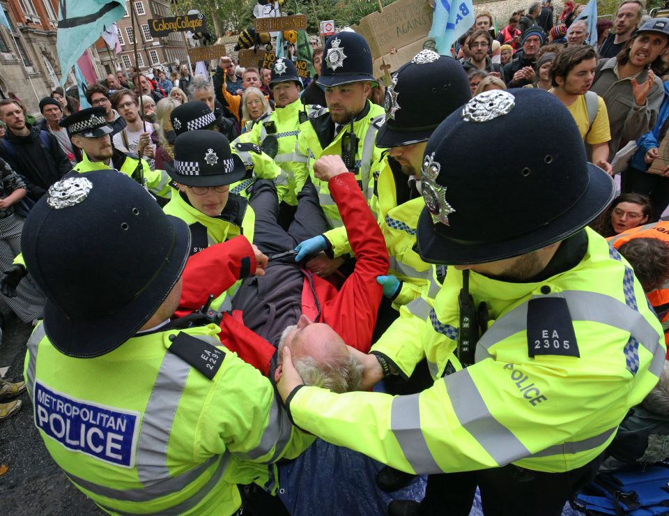  Police arrest a protester at Millbank near to the junction with Great College Street