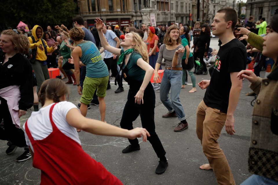  Extinction Rebellion protesters, seen dancing in Trafalgar Square, blocked roads in central London