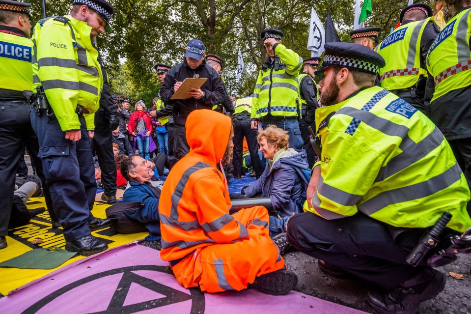  Protesters stuck themselves to the road yesterday to block Millbank