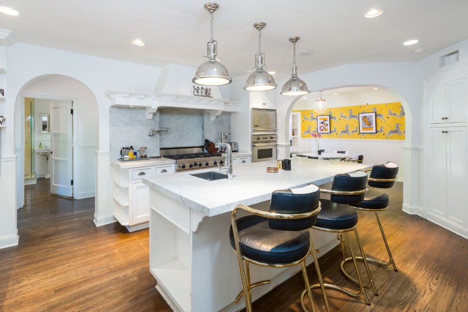 The kitchen is the most contemporary room in the house with white units and stainless steel appliances