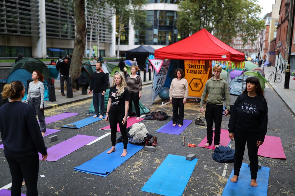  Activists take part in an early morning yoga session on Wednesday