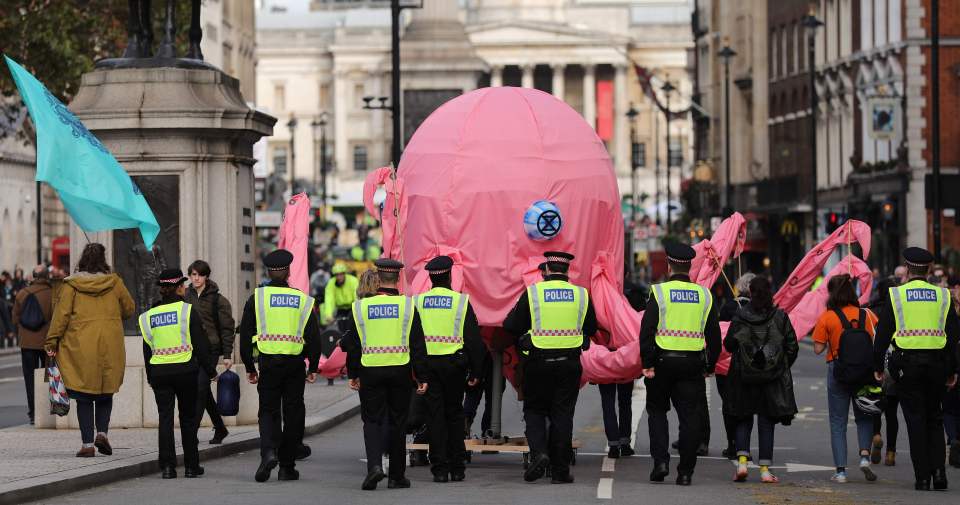  Police march a giant octopus back to Trafalgar Square