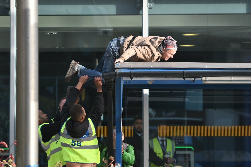  Security try to grab hold of an Extinction Rebellion protester at the airport