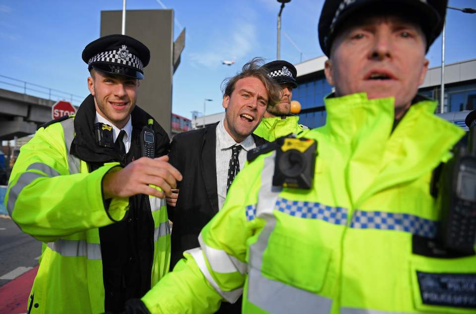  Police arrest an activist on day four of the protests