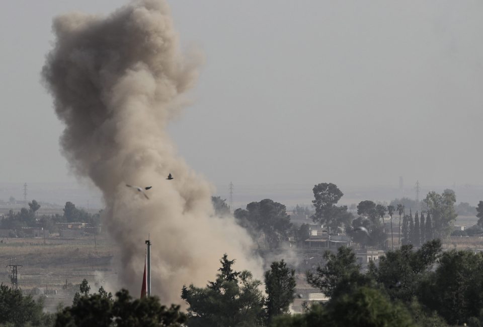 Smoke rises over the Syrian town of Ras al-Ain, as seen from the Turkish border tow