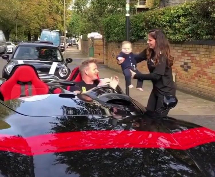  He was sat in the driver's seat of the luxury sports car when wife Tina handed him the baby