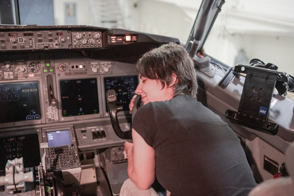  Michele sits in her lover's cockpit