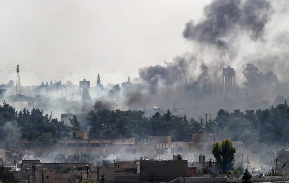 Smoke rises over the Syrian town of Tel Abyad, as seen from the Turkish border town of Akcakale