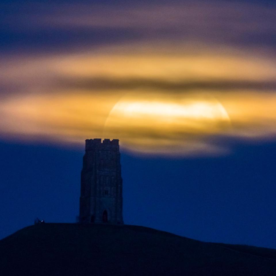  The moon shone through a cloud break in Glastonbury, Somerset