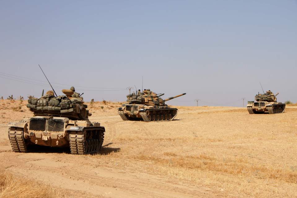 Turkish soldiers drive an American-made M60 tank this morning in the town of Tukhar, north of Syria's northern city of Manbij,