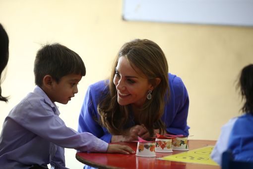  Kate speaks to one child as the royals embark on their first full day of the tour