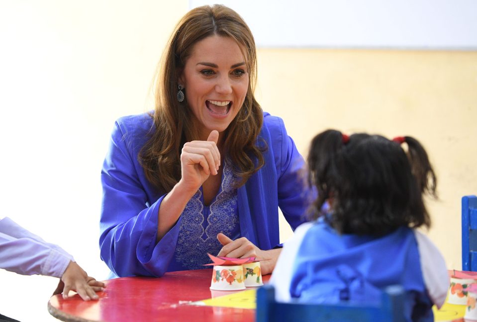  Kate plays with kids at the Islamabad school during the Royal tour