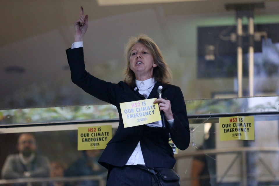 Gail Bradbrook, co-founder of Extinction Rebellion climate action movement, speaks before smashing a window at the front of the building