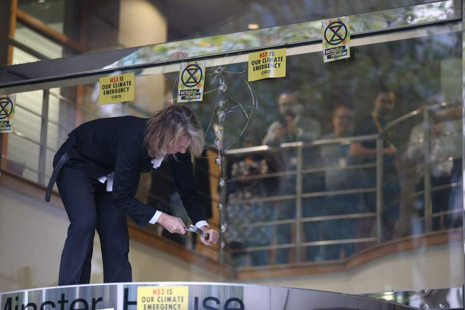  Extinction Rebellion's co-founder Gail Bradbrook , 47, smashes glass with a hammer and screwdriver at the Department of Transport yesterday morning