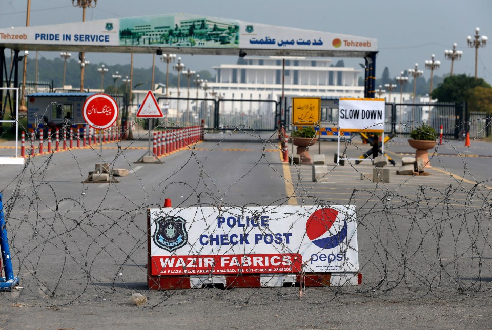  Police cordon off a road with barbed-wire due to security measures for the British Royal couple visit, in Islamabad