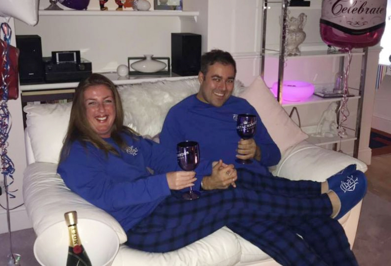  The fantasist seen smiles on her sofa while holding a glass of Moet with partner Craig Hale