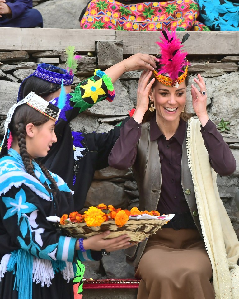 Local women helped her put on the colourful head gear