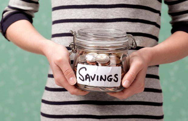 Savings pot being held by woman