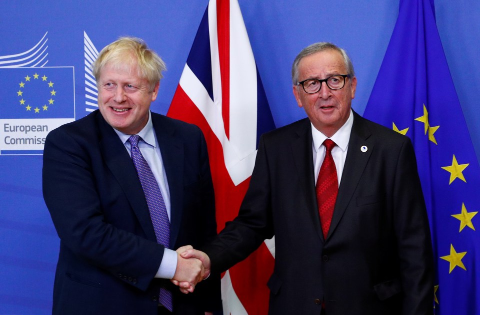  European Commission President Jean-Claude Juncker and Britain's Prime Minister Boris Johnson shake hands during a news conference after agreeing on the Brexit deal